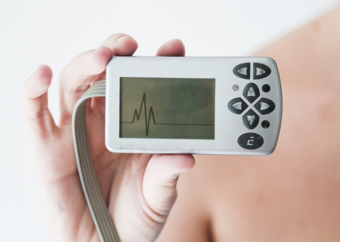 A person holding the wearable device- A 24-hour Holter monitor.